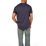 A male model wearing a raw-edged cotton crew neck t-shirt with short sleeves and a rounded hem.