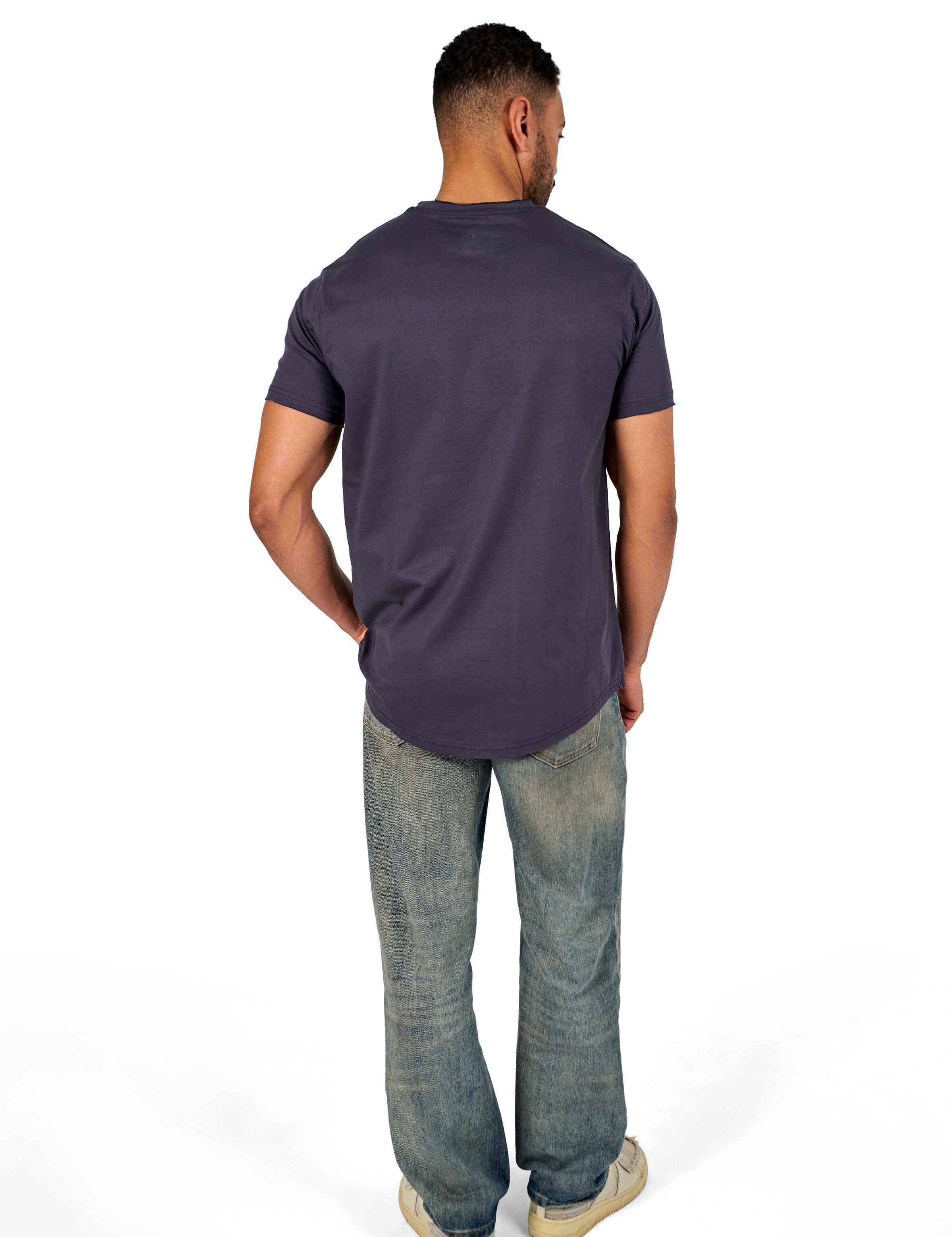 A male model wearing a raw-edged cotton crew neck t-shirt with short sleeves and a rounded hem.