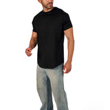 A male model wearing a black raw-edged cotton crew neck t-shirt with short sleeves and a rounded hem.