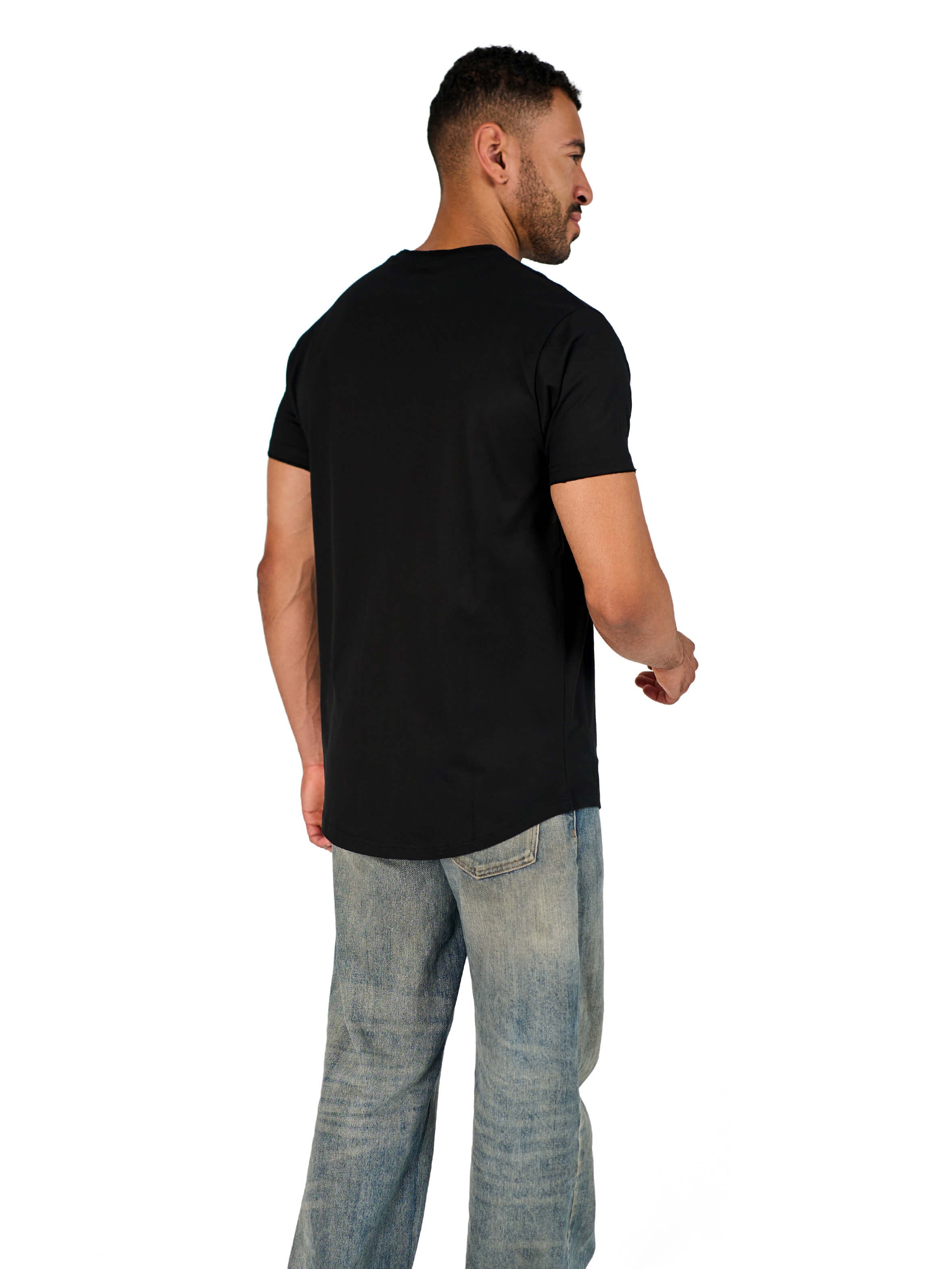 A male model wearing a black raw-edged cotton crew neck t-shirt with short sleeves and a rounded hem.