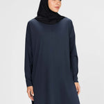 Woman wearing a long-sleeve navy modest loose sports activewear top with a hijab on a white background, branded 'LUXE'.