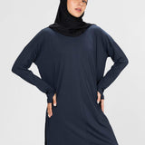 Woman wearing a long-sleeve navy modest loose sports activewear top with a hijab on a white background, branded 'LUXE'.